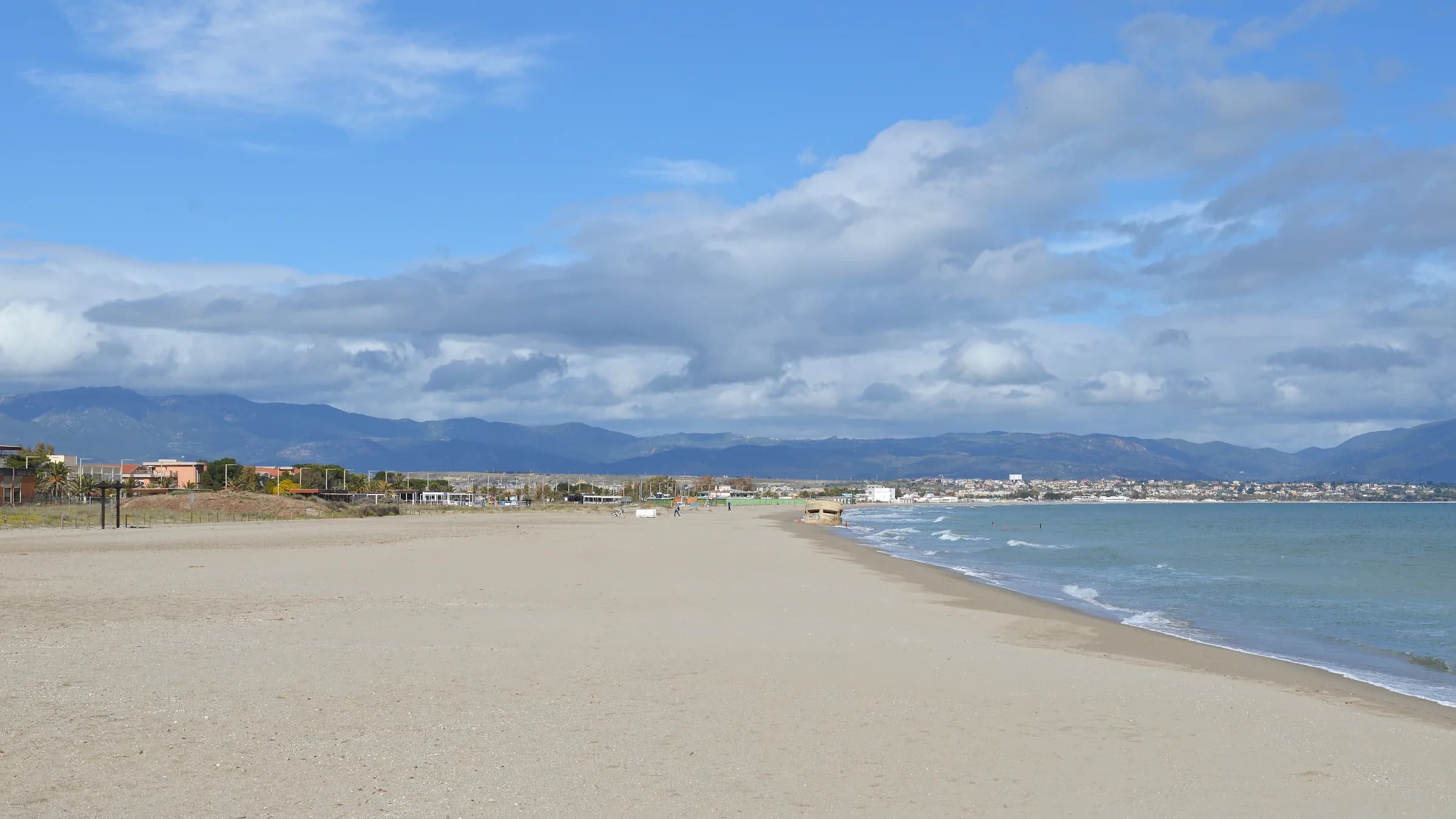 The sandy shoreline of Poetto beach in Cagliari